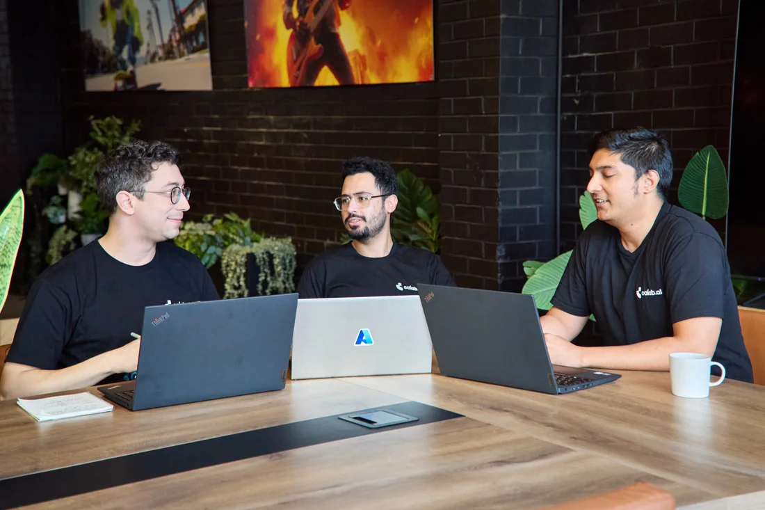 Calab.ai engineers discussing their work around a table