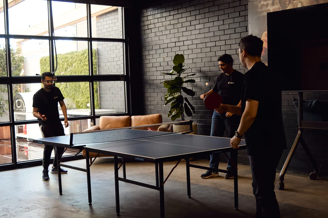 Calab.ai colleagues playing table tennis
